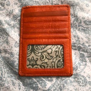 Orange leather credit card holder.